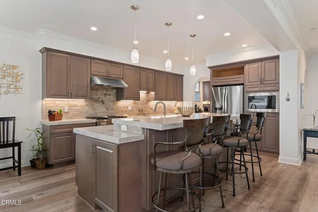 a large kitchen with kitchen island a sink table and chairs
