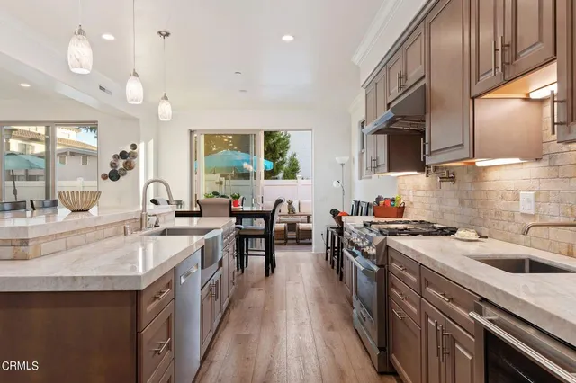 a kitchen with sink stove and cabinets