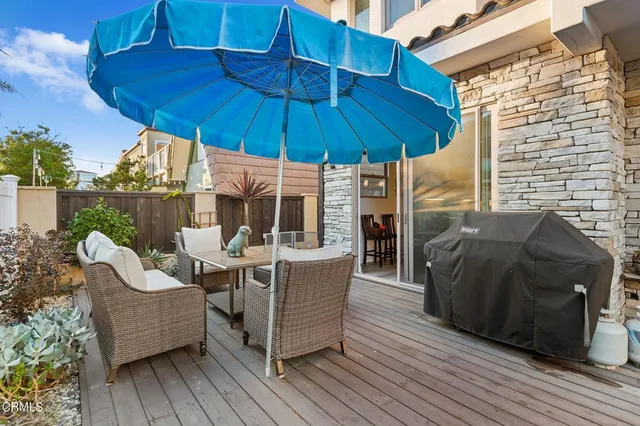 a patio of a house with table and chairs