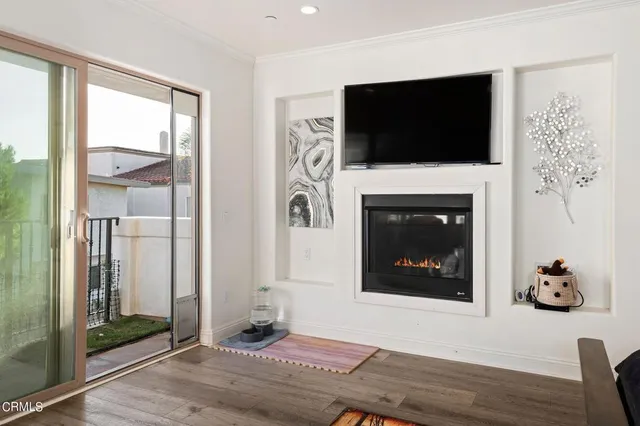a living room with a flat screen tv and a fireplace