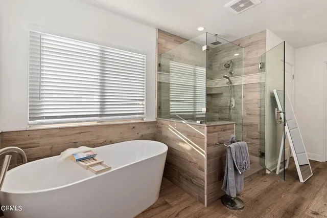 a bathroom with a bathtub and a shower