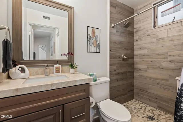 a bathroom with a sink a toilet and mirror