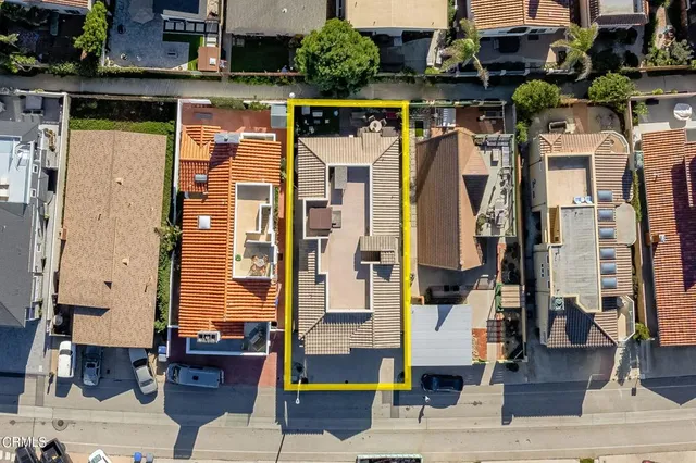 an aerial view of residential houses with outdoor space