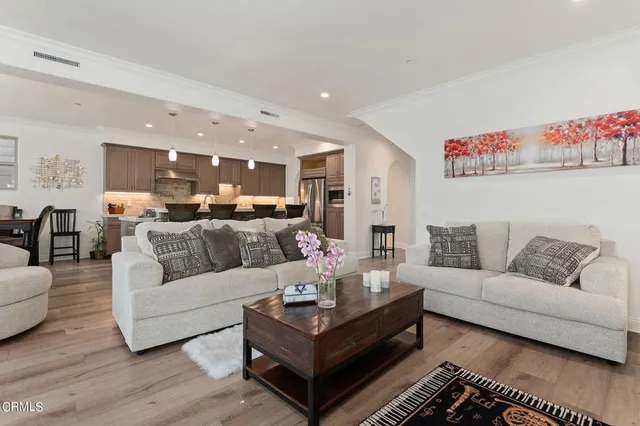 a living room with furniture kitchen view and a couch