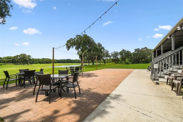 a view of a room with gym equipment and wooden floor