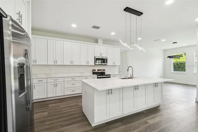a kitchen with a sink appliances and cabinets