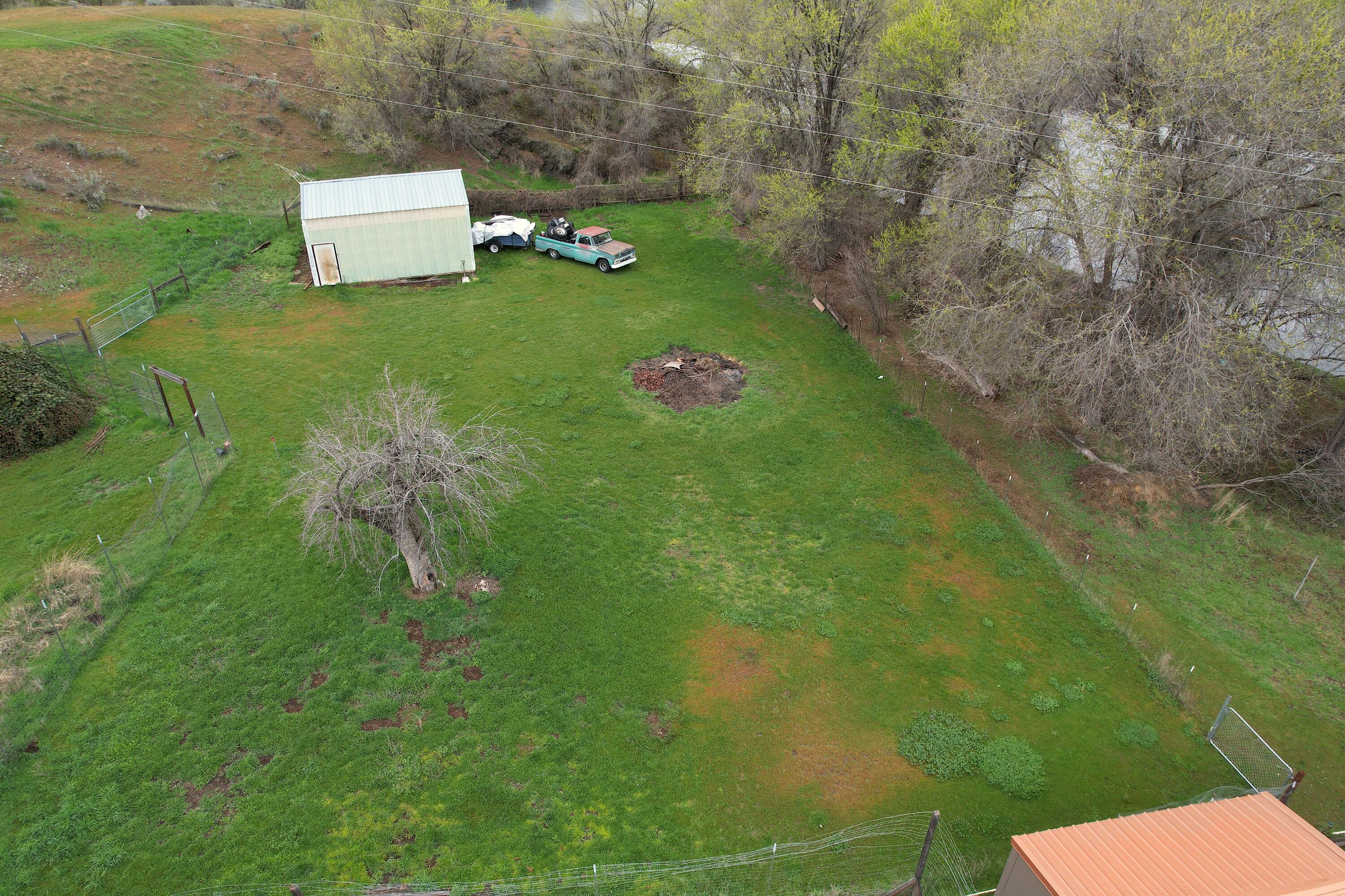 298 Main Street Monument, OR 97864 - Photo 58 of 66 a backyard of a house with lots of green space and a lake view