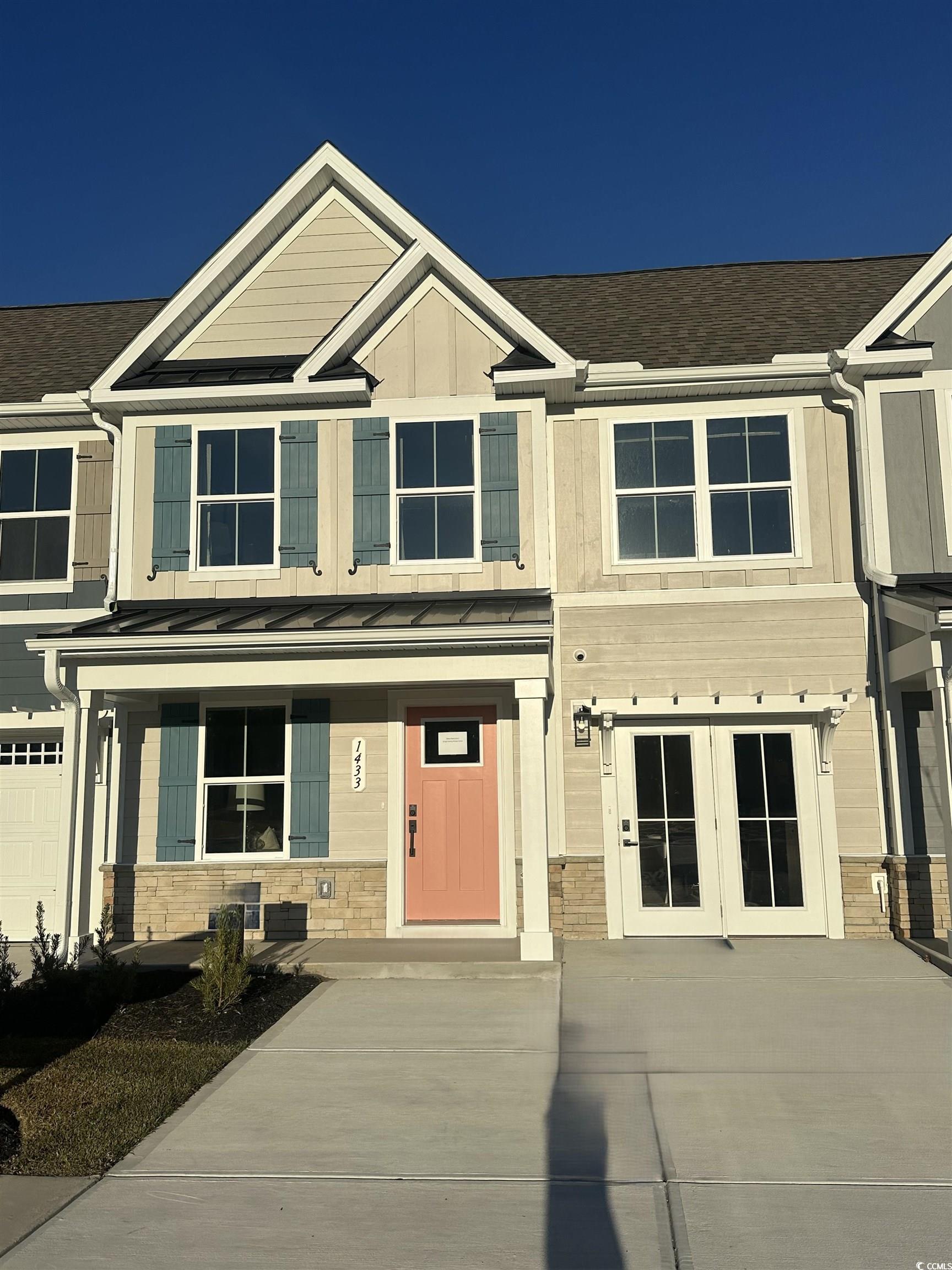 Craftsman house featuring stone siding, a standing seam roof, a metal roof, and roof with shingles