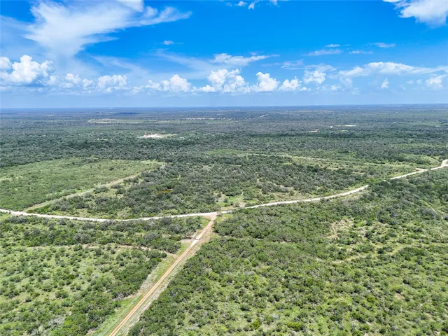 a view of a field with an ocean
