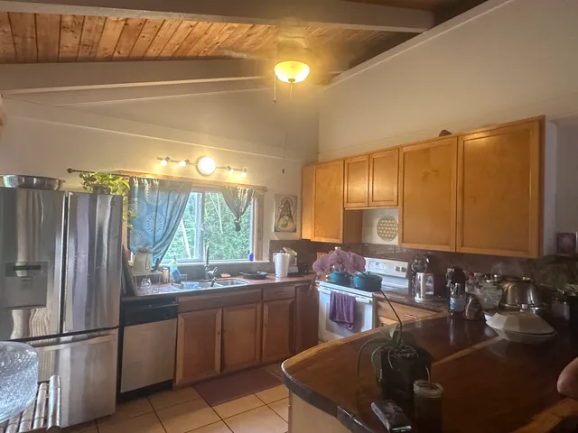 a kitchen with sink a window and cabinets
