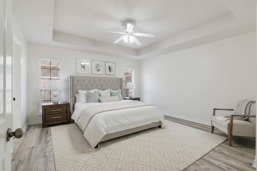3750 Castlegate Drive Paris, TX 75462 - Photo 11 of 20 a bedroom with a bed and a chandelier