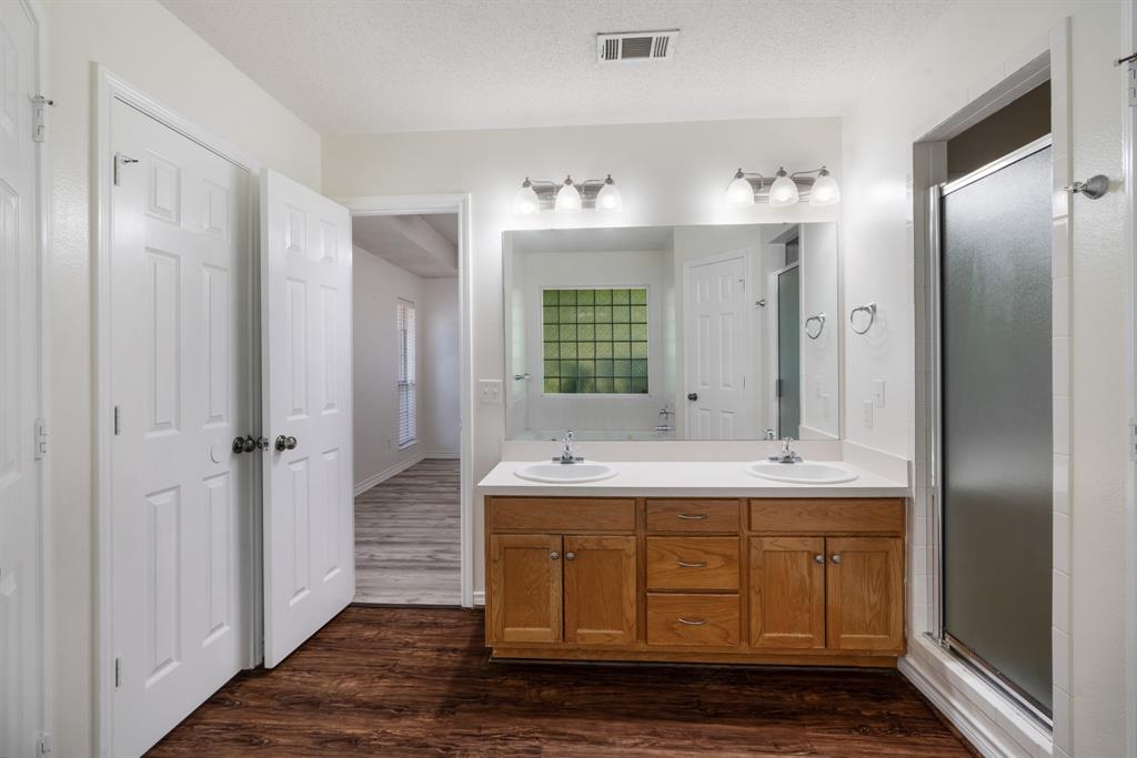 3750 Castlegate Drive Paris, TX 75462 - Photo 13 of 20 a bathroom with a double vanity sink and mirror