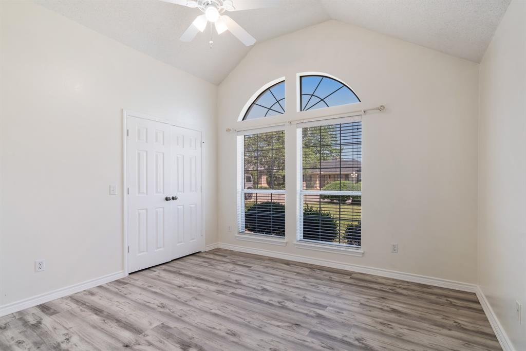 3750 Castlegate Drive Paris, TX 75462 - Photo 14 of 20 an empty room with wooden floor cabinet and a window