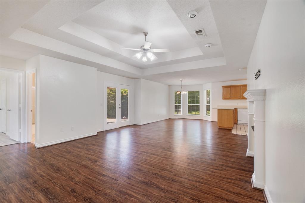 3750 Castlegate Drive Paris, TX 75462 - Photo 3 of 20 a view of empty room with wooden floor and fireplace