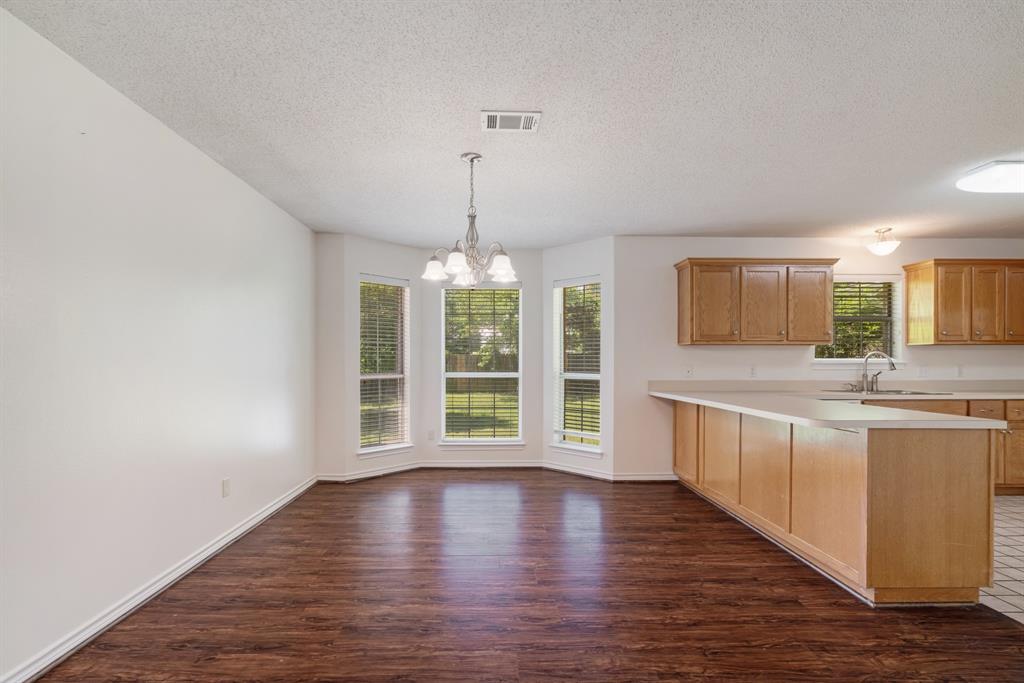 3750 Castlegate Drive Paris, TX 75462 - Photo 7 of 20 a view of a kitchen with a sink wooden floor and a window
