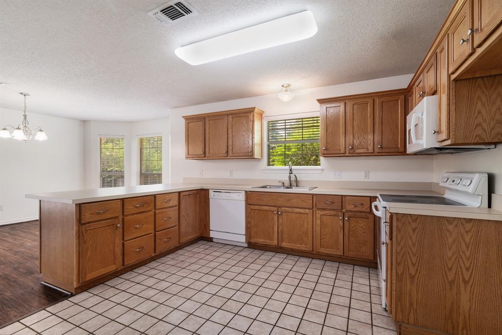 3750 Castlegate Drive Paris, TX 75462 - Photo 9 of 20 a kitchen with sink cabinets and window