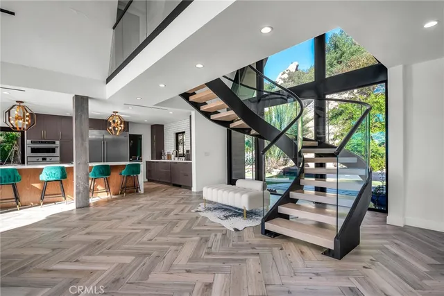 a dining room with furniture a large window and a chandelier