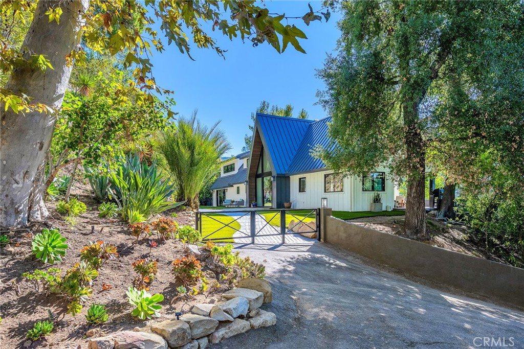 24301 Sylvan Glen Road Calabasas, CA 91302 - Photo 2 of 64 a view of a house with a yard and sitting area