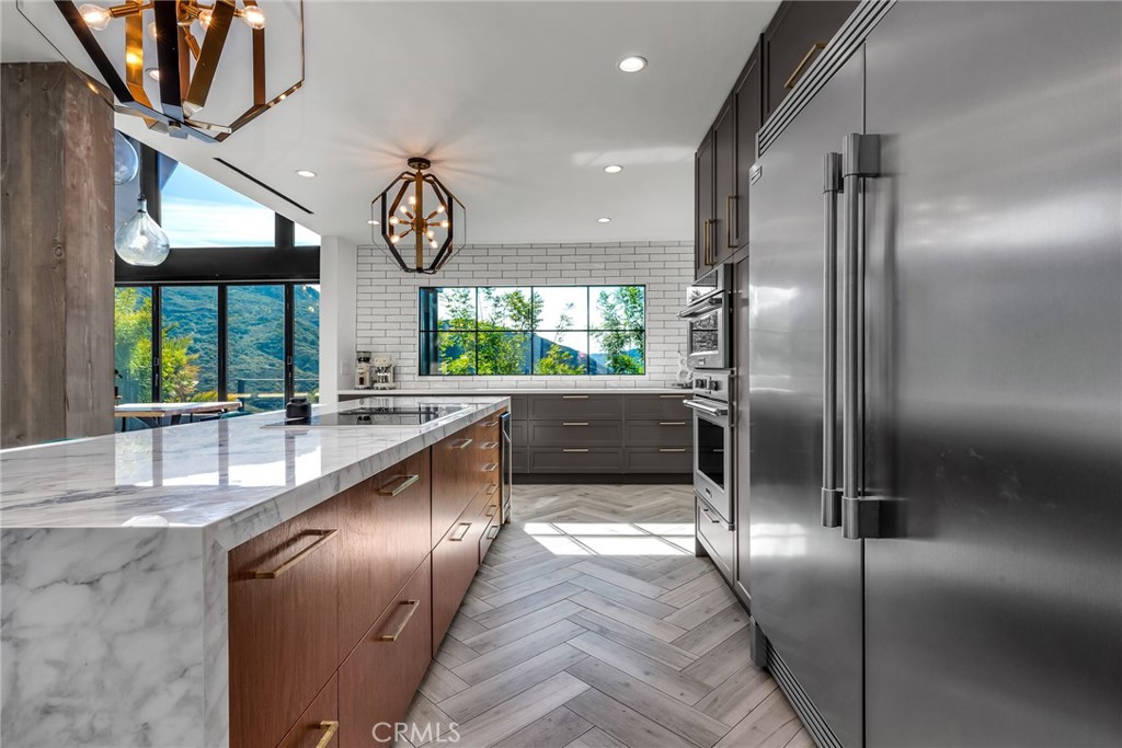 24301 Sylvan Glen Road Calabasas, CA 91302 - Photo 29 of 64 an open kitchen with a sink and a large window