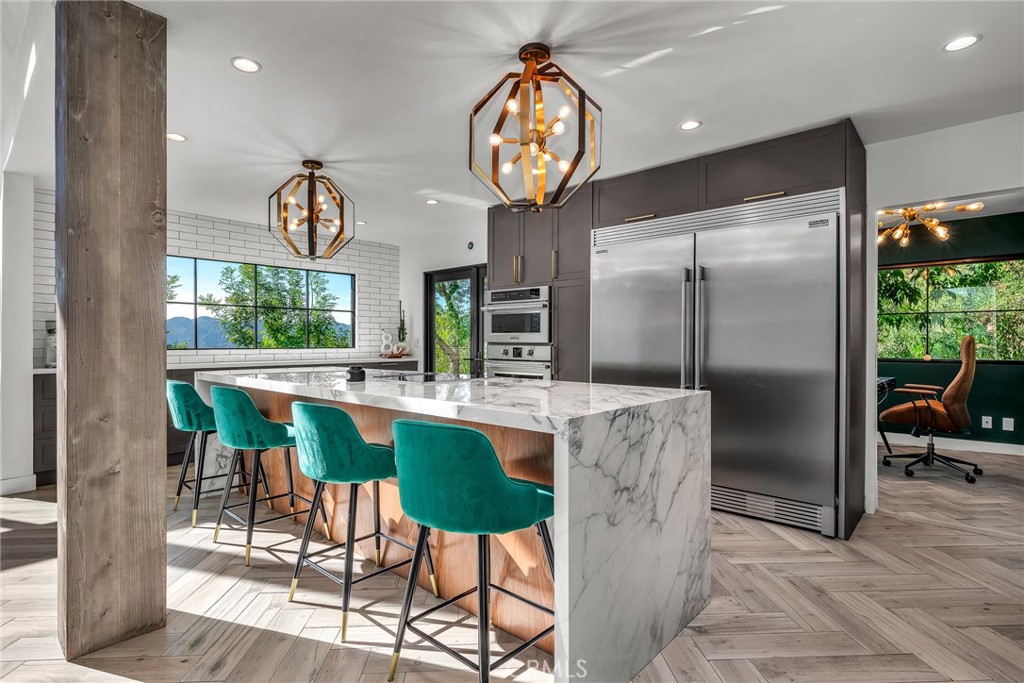 24301 Sylvan Glen Road Calabasas, CA 91302 - Photo 30 of 64 a kitchen with a table and chairs
