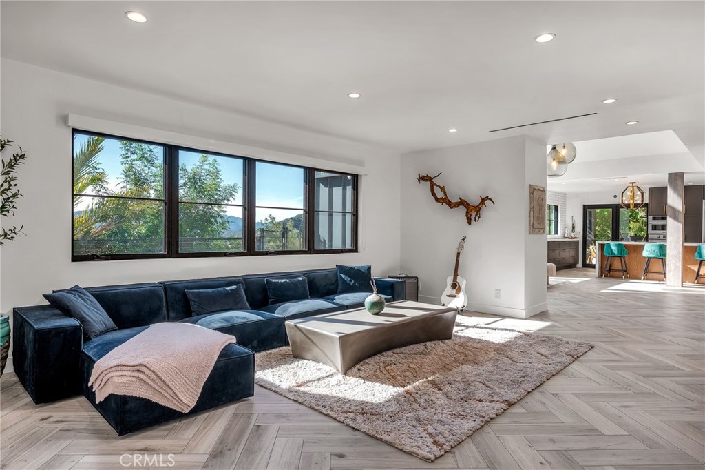 24301 Sylvan Glen Road Calabasas, CA 91302 - Photo 34 of 64 a living room with furniture and a large window