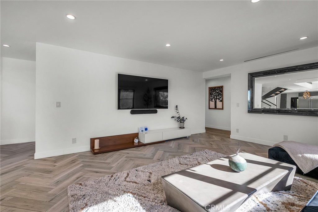 24301 Sylvan Glen Road Calabasas, CA 91302 - Photo 36 of 64 a living room with furniture and a flat screen tv