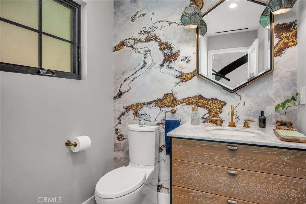 24301 Sylvan Glen Road Calabasas, CA 91302 - Photo 37 of 64 a bathroom with a sink a toilet and shower curtain