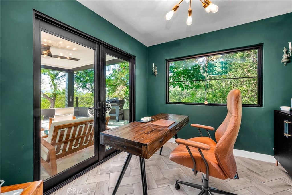 24301 Sylvan Glen Road Calabasas, CA 91302 - Photo 38 of 64 a view of a dining room with furniture large windows and wooden floor