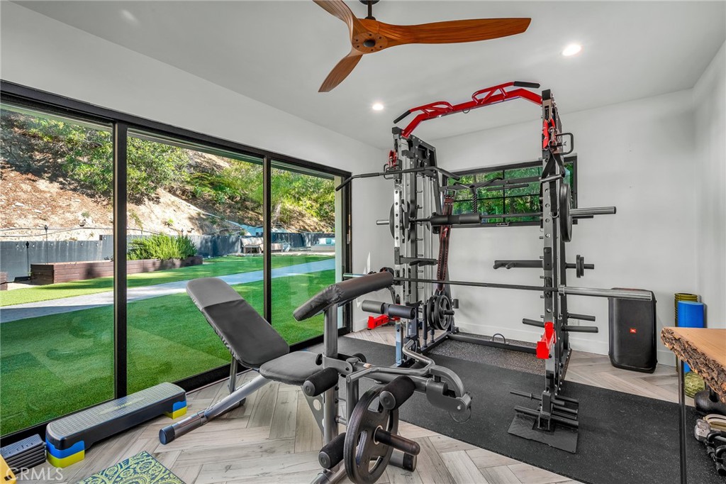 24301 Sylvan Glen Road Calabasas, CA 91302 - Photo 39 of 64 a bedroom with furniture and a floor to ceiling window