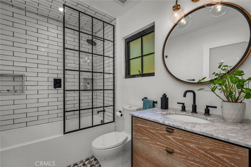 24301 Sylvan Glen Road Calabasas, CA 91302 - Photo 40 of 64 a bathroom with a granite countertop toilet sink and mirror