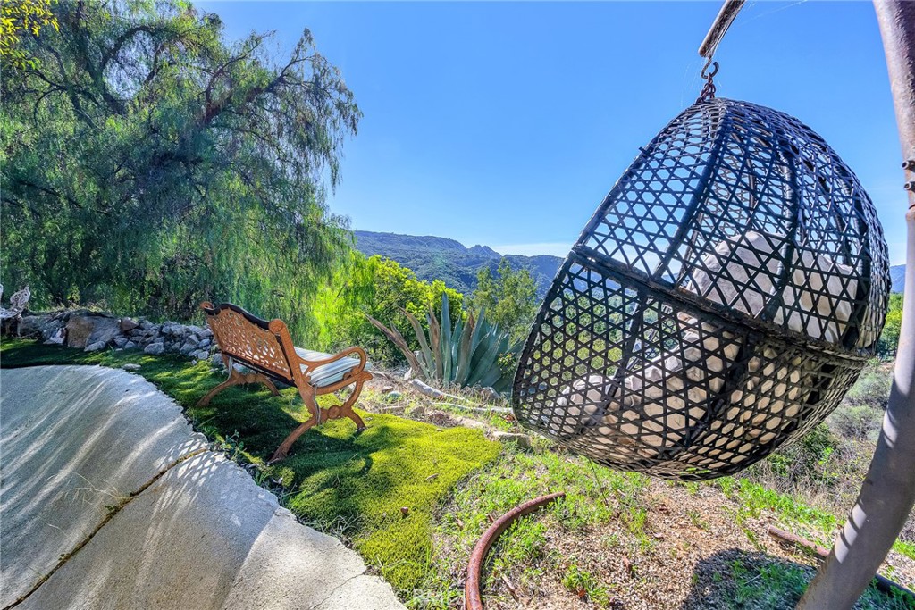 24301 Sylvan Glen Road Calabasas, CA 91302 - Photo 57 of 64 a view of a chairs and table in the backyard