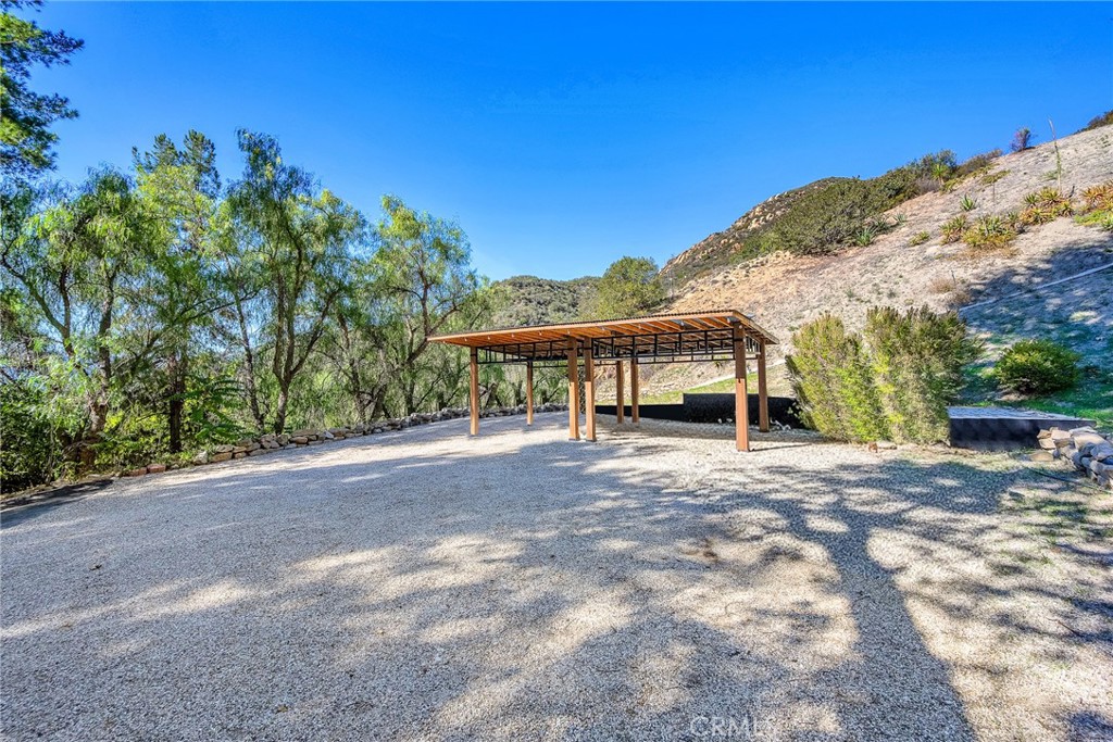 24301 Sylvan Glen Road Calabasas, CA 91302 - Photo 62 of 64 a view of a house with a yard and mountain