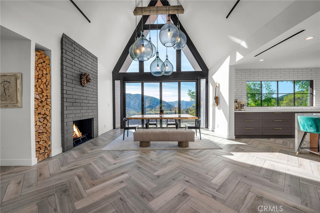 24301 Sylvan Glen Road Calabasas, CA 91302 - Photo 10 of 64 a view of a livingroom with a fireplace and large windows