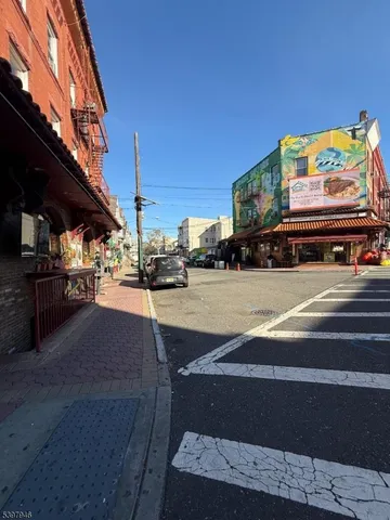 a view of building along with the road and shops