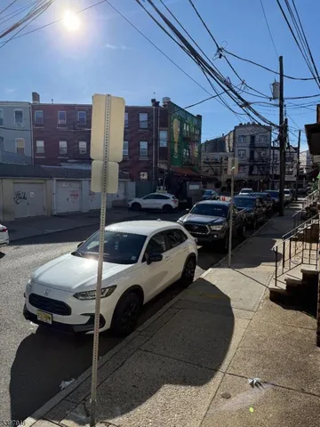 a view of a patio with table and chairs under an umbrella