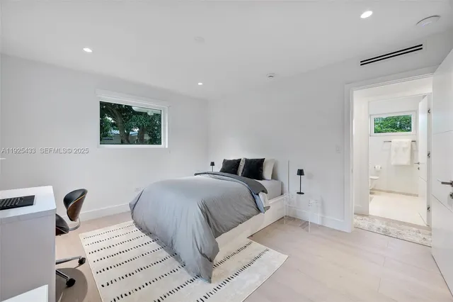 a bedroom with a bed and a desk