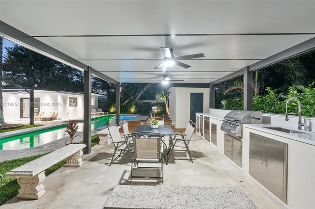 a view of a patio with a table chairs and a porch