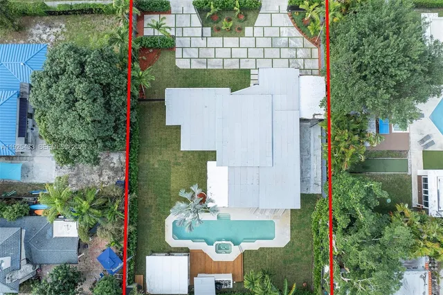 an aerial view of a house with a yard and lake view