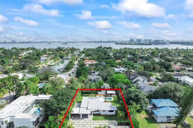 an aerial view of residential house and car parked