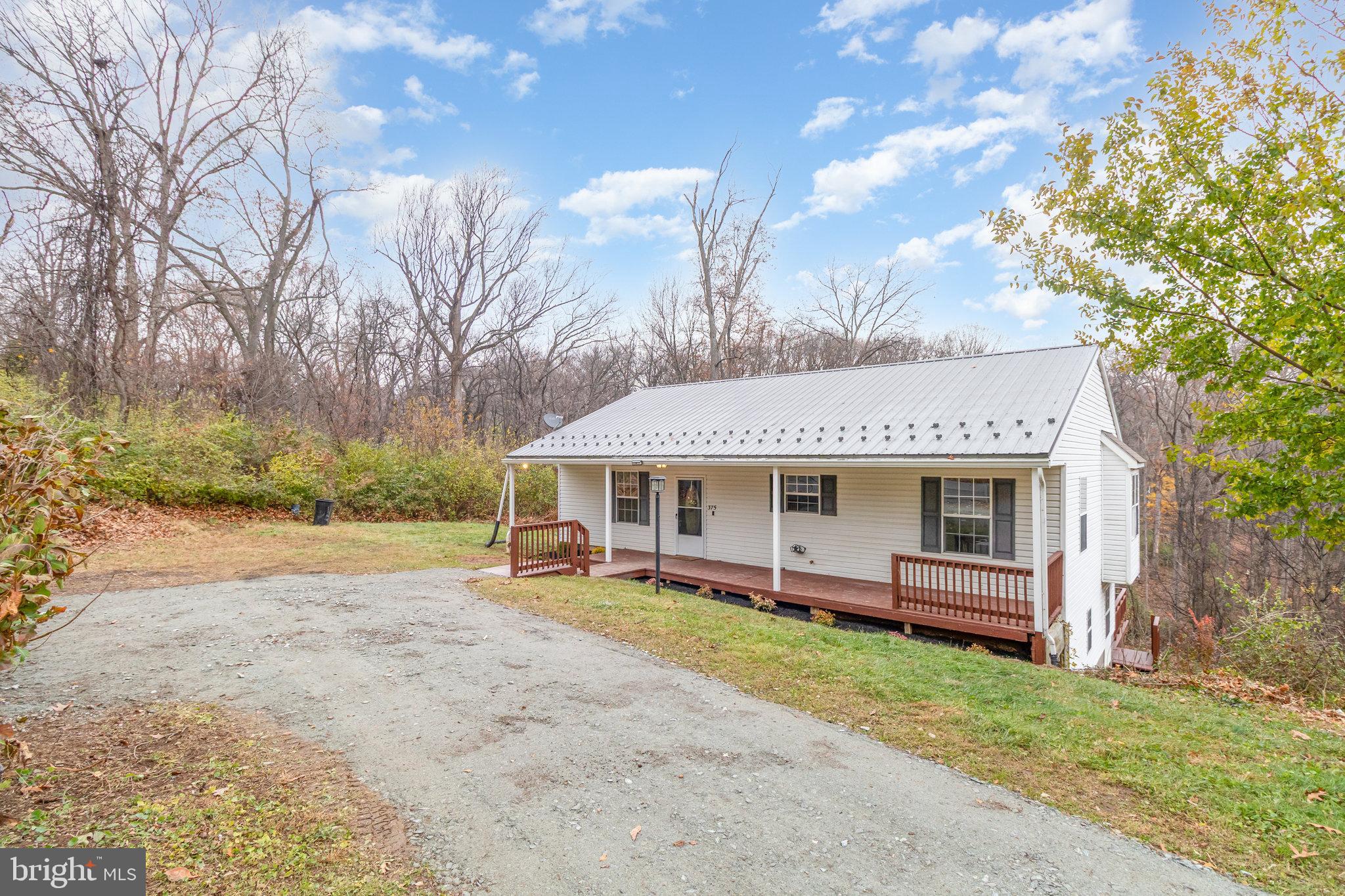 375 Meadow Trail Delta, PA 17314 - Photo 18 of 22 a view of a house with backyard and a tree