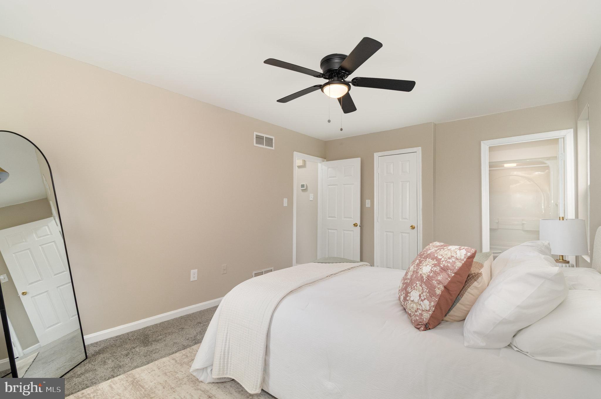 375 Meadow Trail Delta, PA 17314 - Photo 10 of 22 a bedroom with a large bed and a chandelier