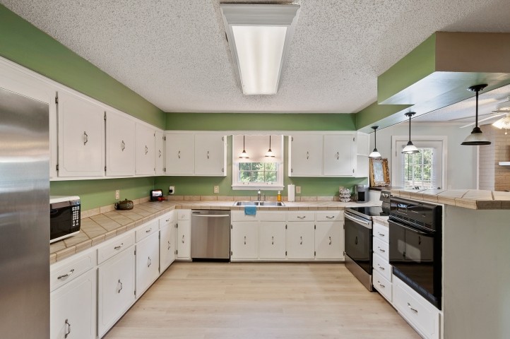 4039 Arno Road Franklin, TN 37064 - Photo 13 of 58 a kitchen with a sink stove top oven and cabinets