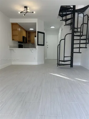 a view of a livingroom with furniture and staircase