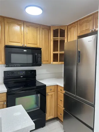a kitchen with a refrigerator and a sink