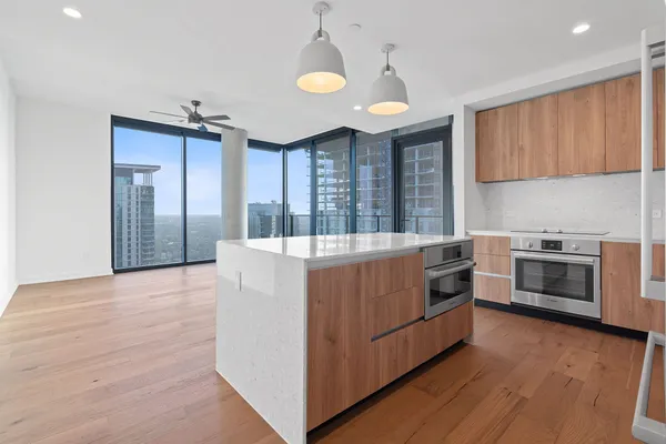a kitchen with granite countertop a sink cabinets and stainless steel appliances