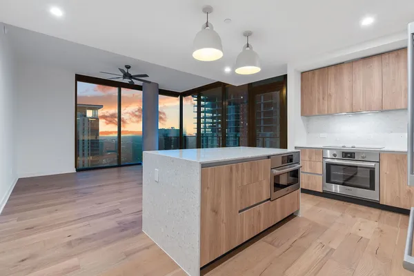 a kitchen with stainless steel appliances granite countertop a stove a sink and a refrigerator