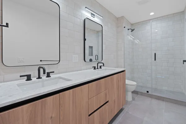 a bathroom with 2 sink and a mirror