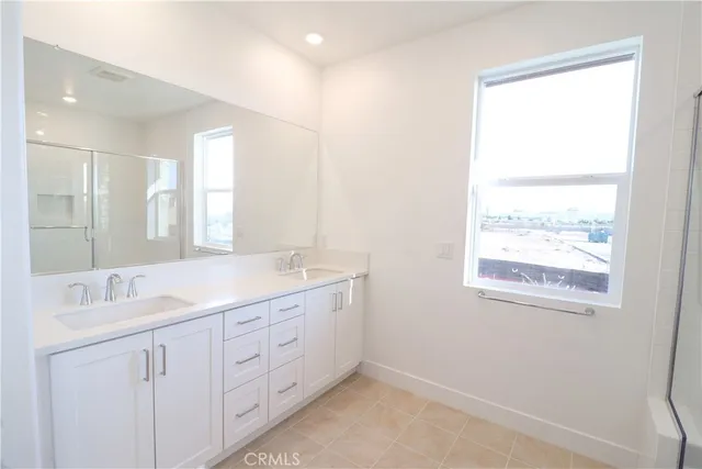a bathroom with a granite countertop sink mirror and double