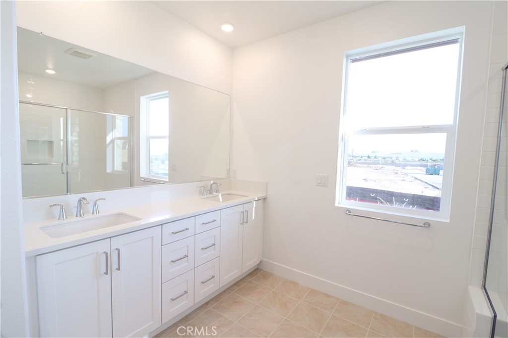 647 Gadwall Irvine, CA 92618 - Photo 13 of 29 a bathroom with a granite countertop sink mirror and double