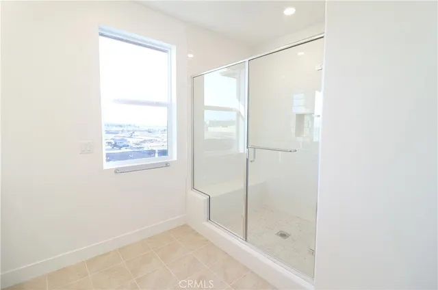 a bathroom with a glass shower door